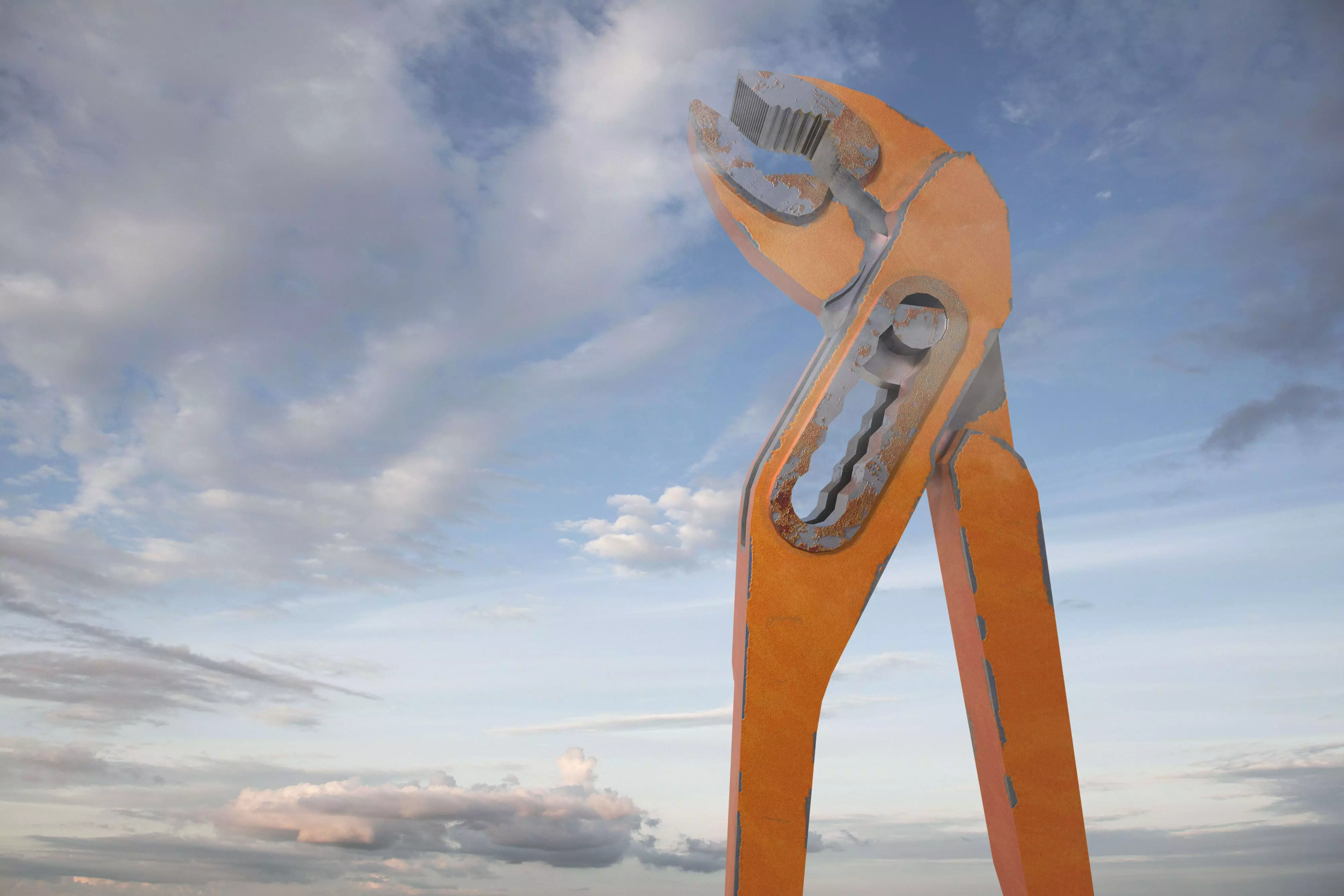 alt="Giant orange pliers standing against a bright blue sky with clouds."