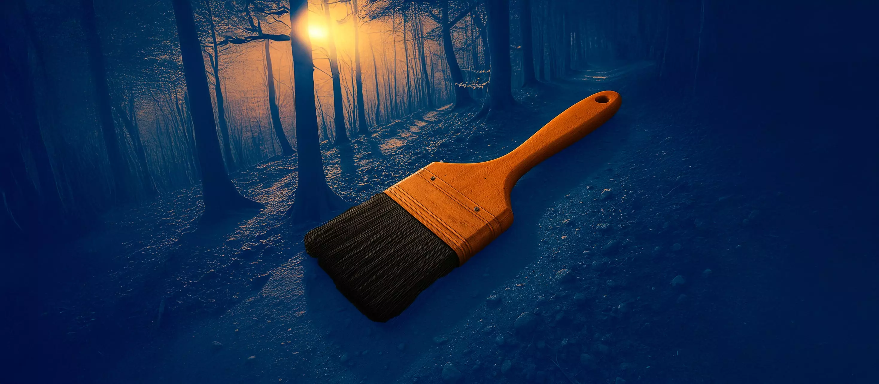 Large industrial painting brush placed in an autumn forest.