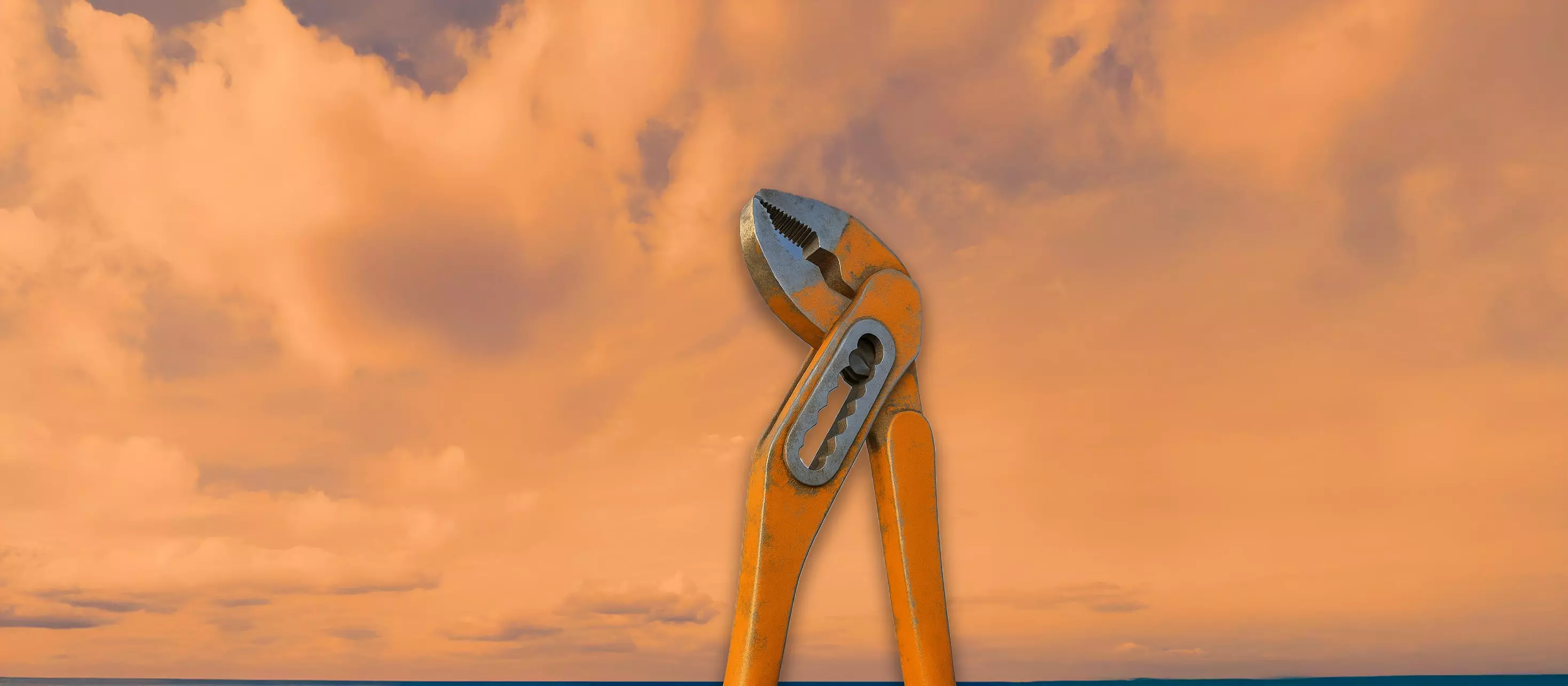 Giant orange pliers standing against a sky with clouds.