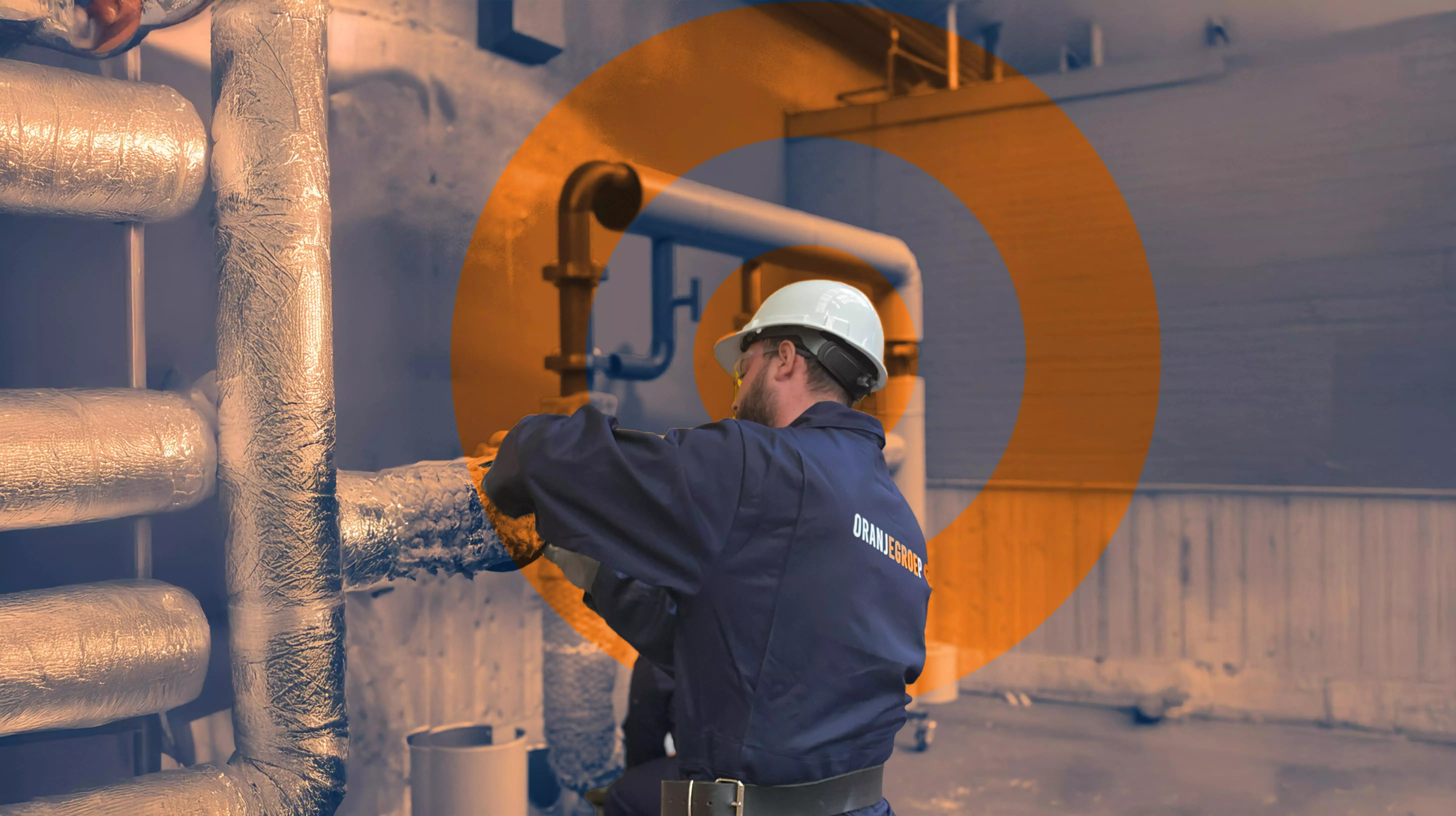 Worker wearing a white helmet and ORANJEGROEP uniform installing or insulating pipes in an industrial setting.