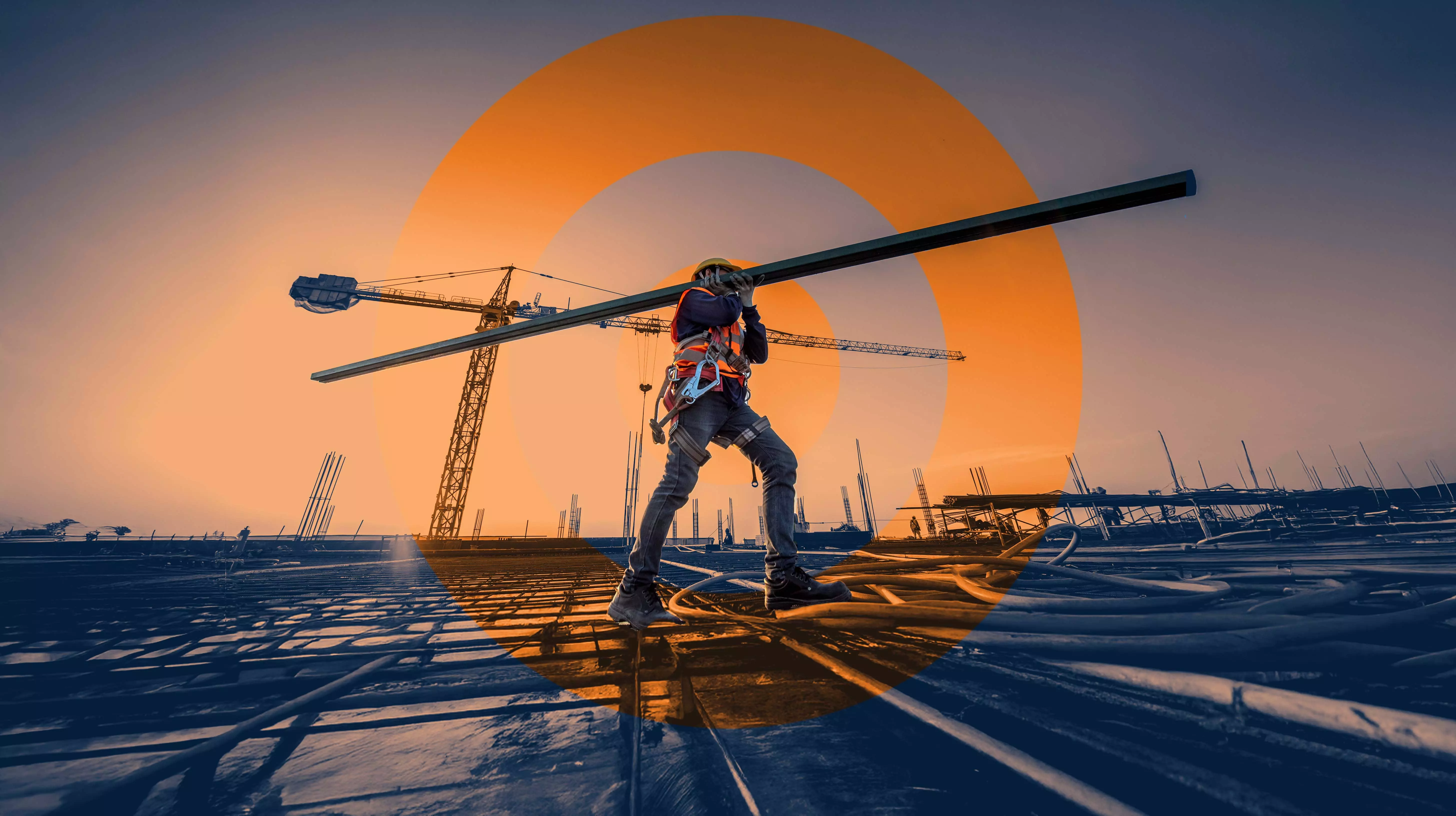 Construction worker carrying a metal beam across a building site with cranes and big ORANJEGROEP  logo in the background, symbolizing strength and progress.