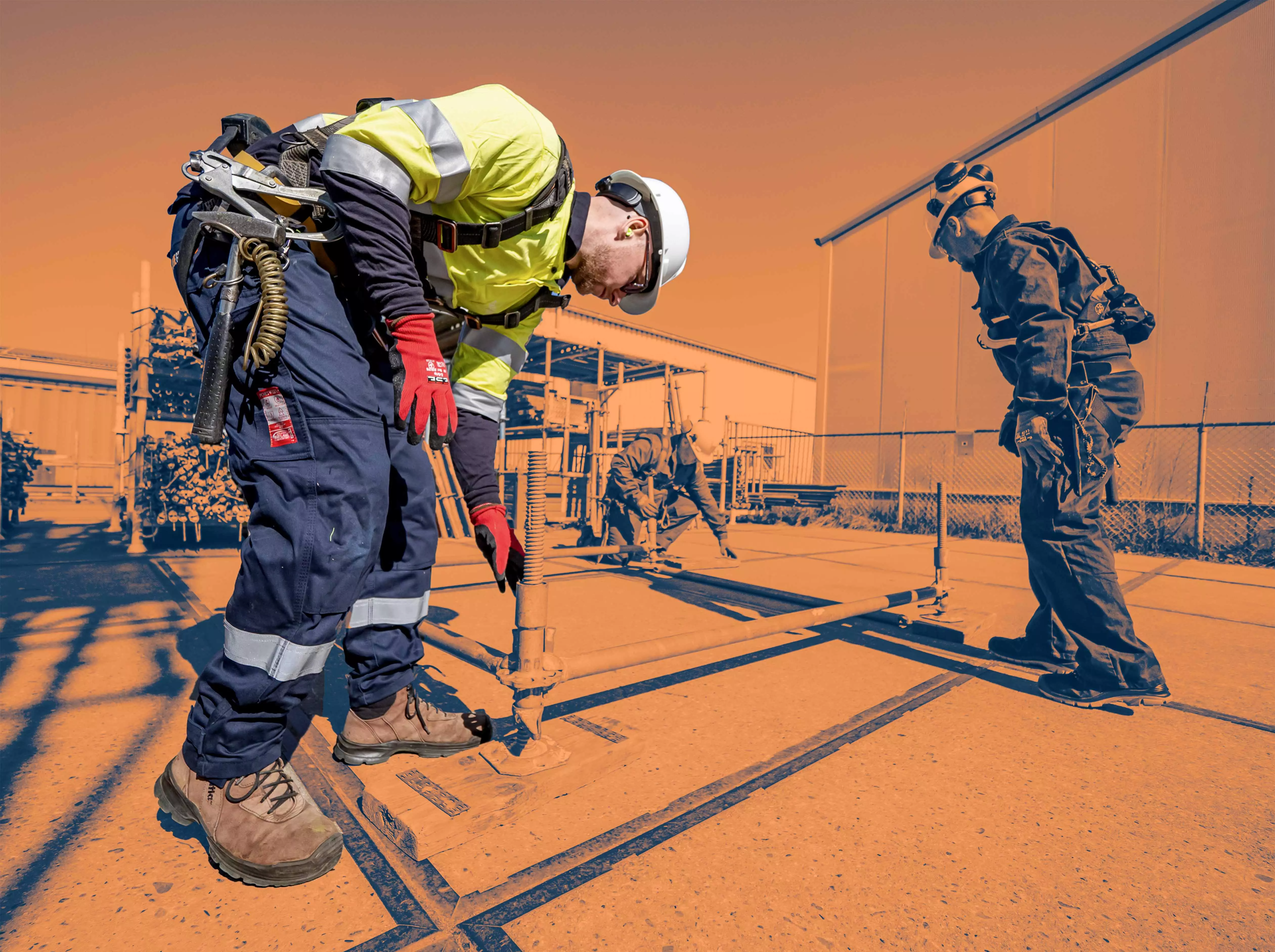 Close-up of two construction workers shaking hands while wearing gloves, symbolizing trust and partnership.
